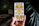 Close-up photo of a hand holding an illustrated tarot card featuring a calming oak tree.