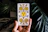 Close-up photo of a hand holding an illustrated tarot card featuring a calming oak tree.