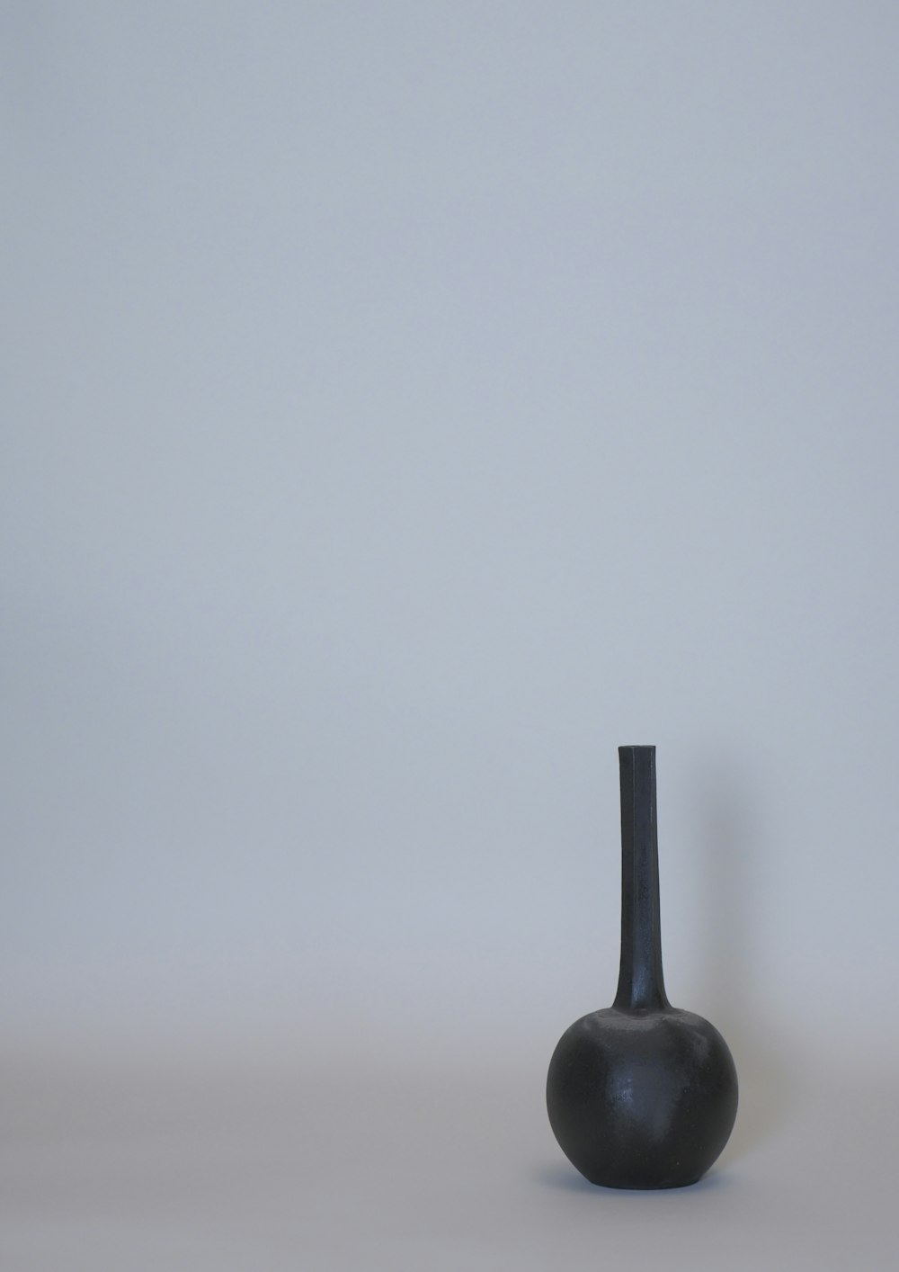 black ceramic vase on white table