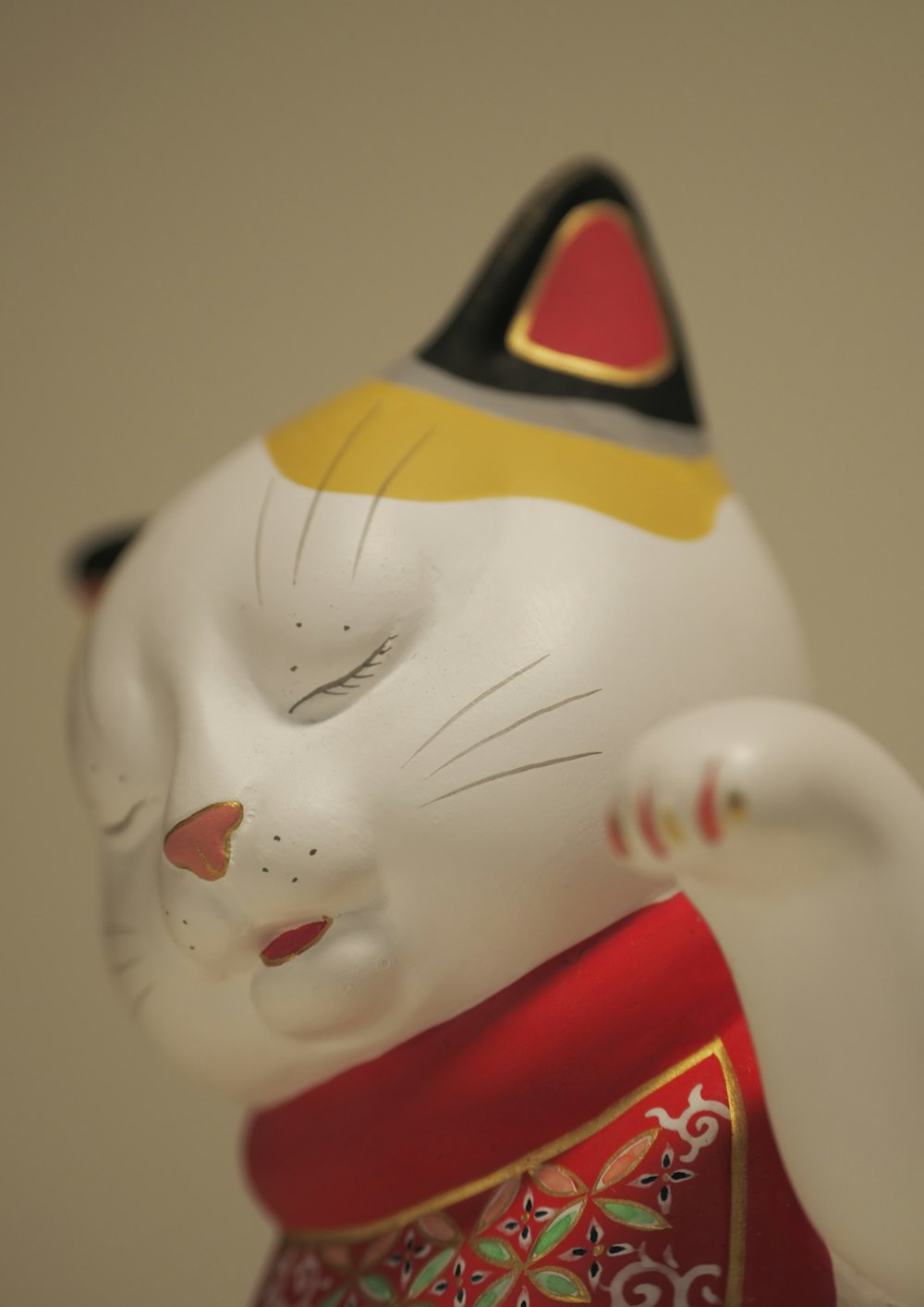 white and red cat figurine