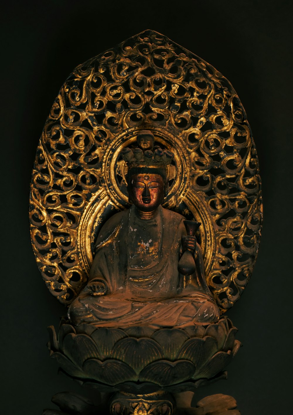 gold and black hindu deity figurine
