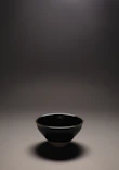 A delicate 3D printed decorative bowl in lavender, placed on a minimalist white shelf with soft shadows