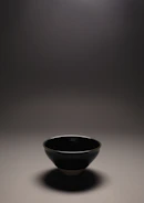 A delicate 3D printed decorative bowl in lavender, placed on a minimalist white shelf with soft shadows