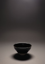 Close-up of a handcrafted ceramic bowl with subtle earthy textures and soft natural light.