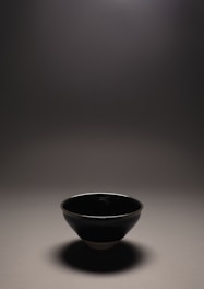 Handcrafted ceramic bowls with subtle gray matte finish, softly lit by natural light