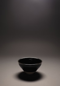 Handcrafted ceramic bowls with subtle gray matte finish, softly lit by natural light