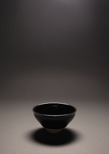 Close-up of a handcrafted ceramic bowl with subtle earthy textures and soft natural light.