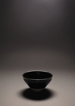 Close-up of a serene clay bowl with natural textures and soft lighting.