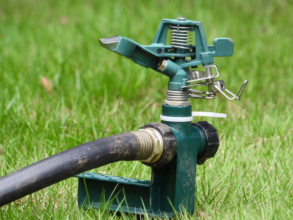 black and yellow metal tool on green grass during daytime