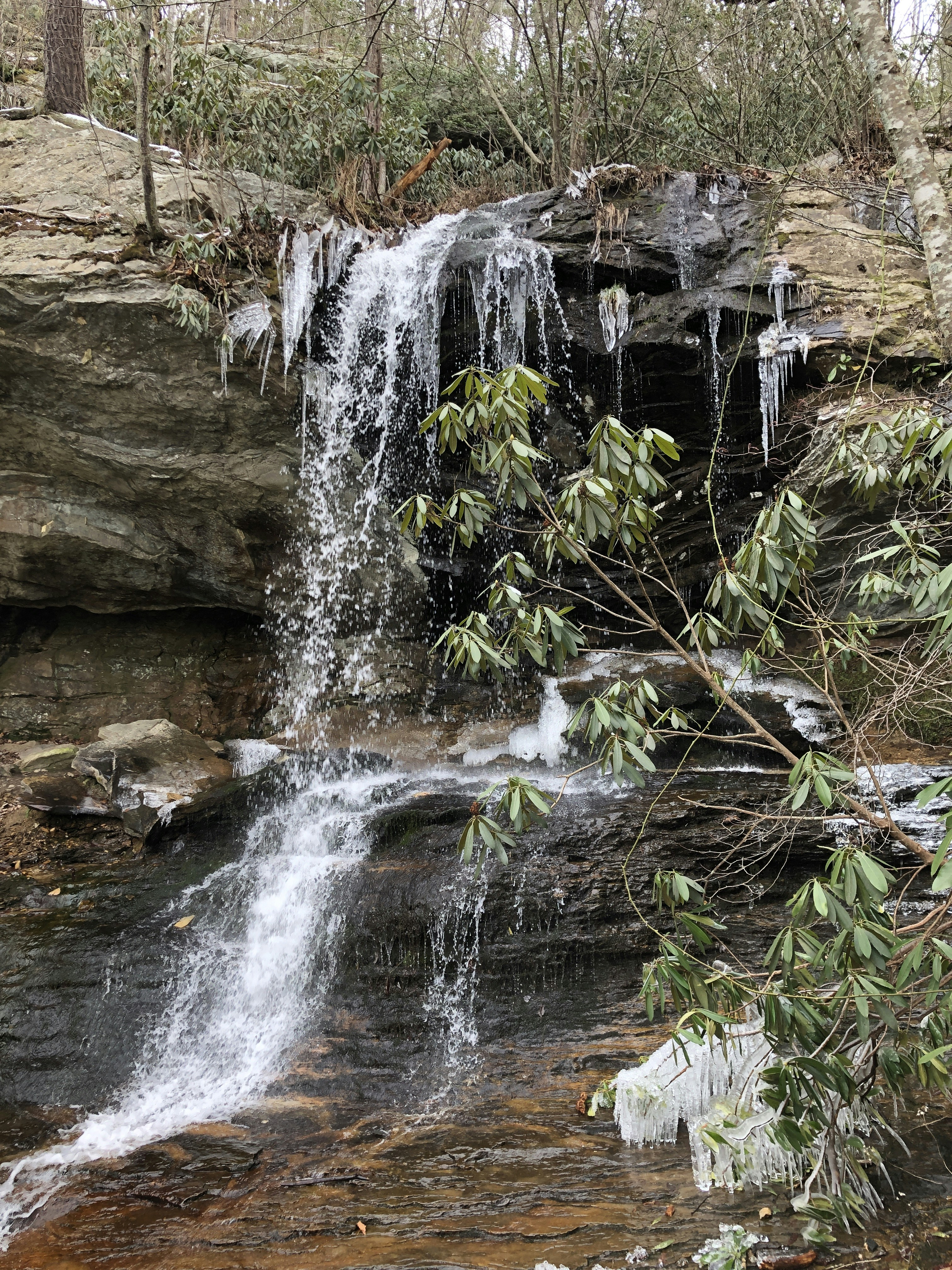 A waterfall with icicles hanging off of it's sides photo – Free River ...
