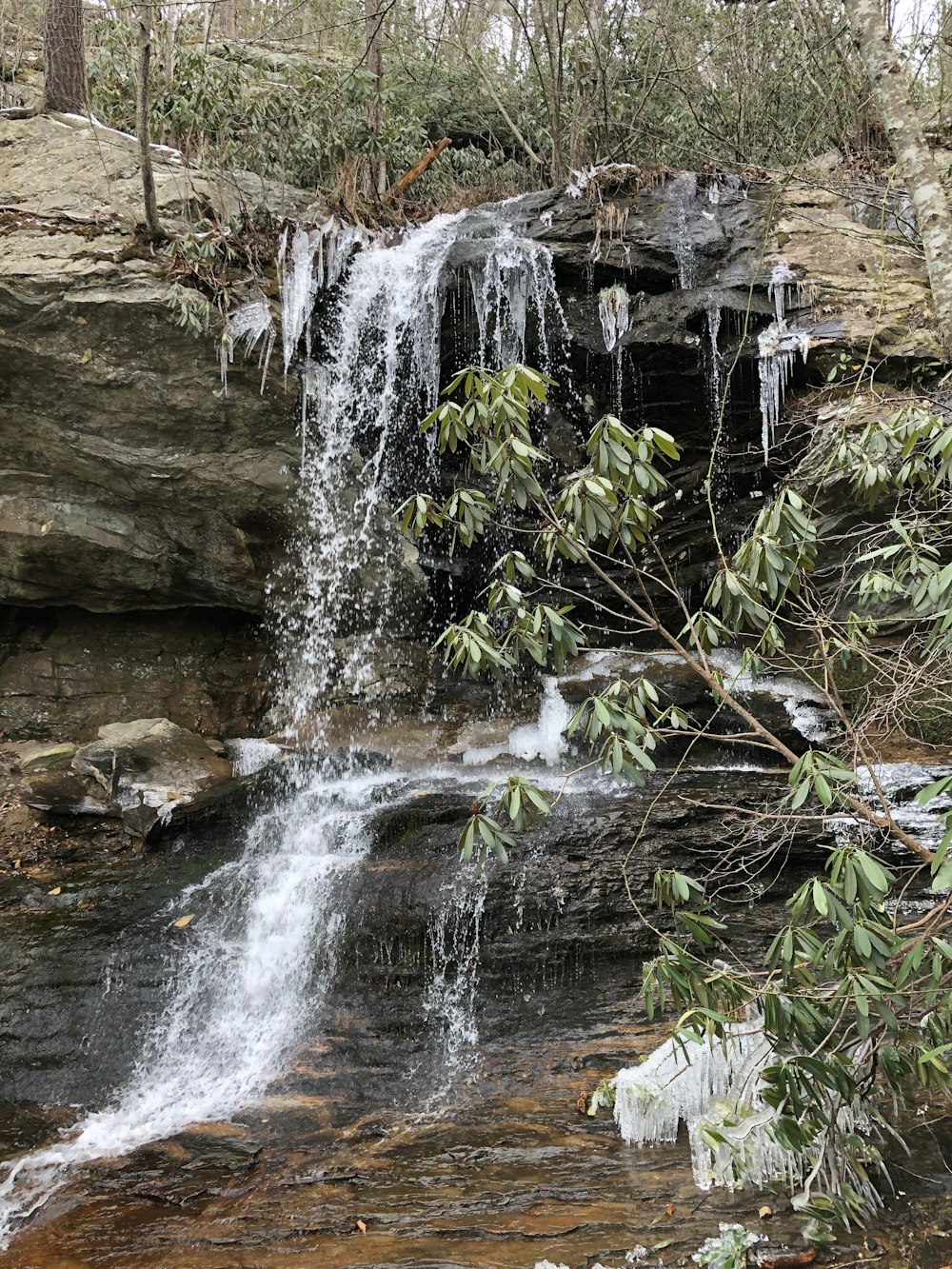 a waterfall with icicles hanging off of it's sides