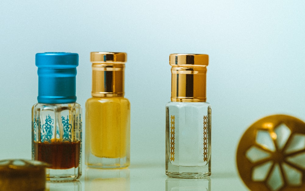 three glass bottles on white table