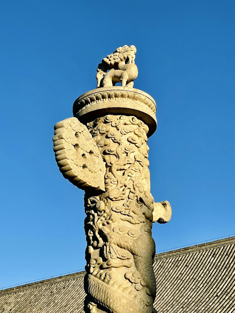 brown concrete statue under blue sky during daytime