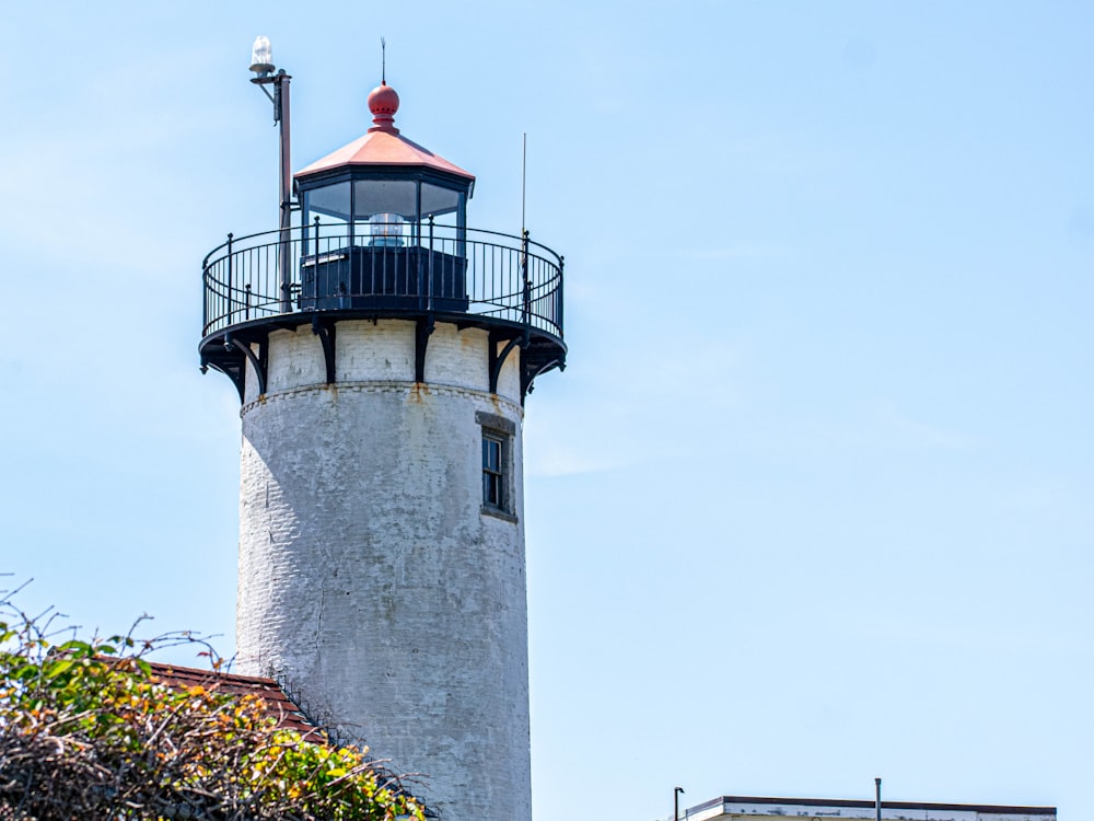 white and black lighthouse under white sky during daytime