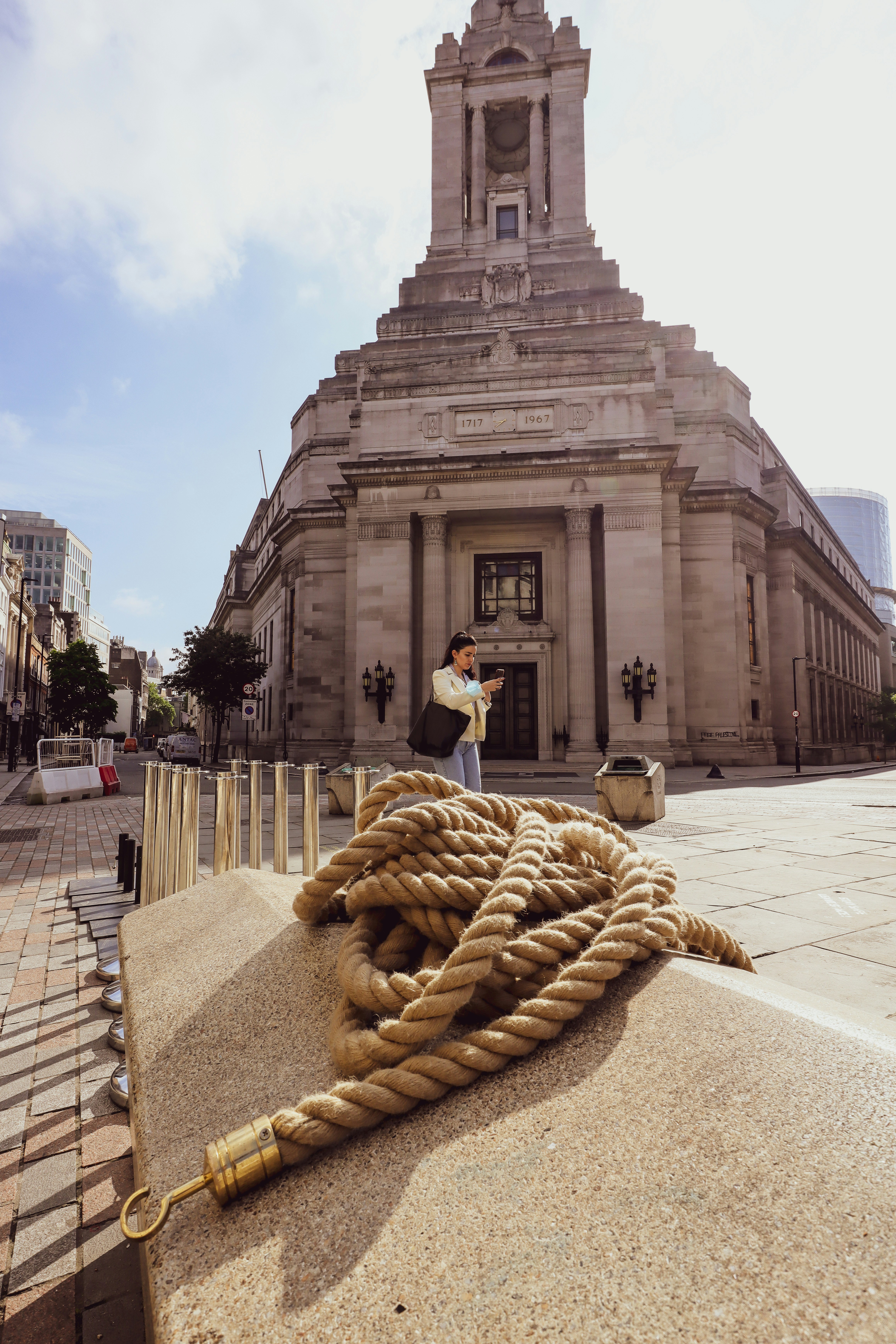 woman in white shirt and black pants standing on gray concrete floor during daytime