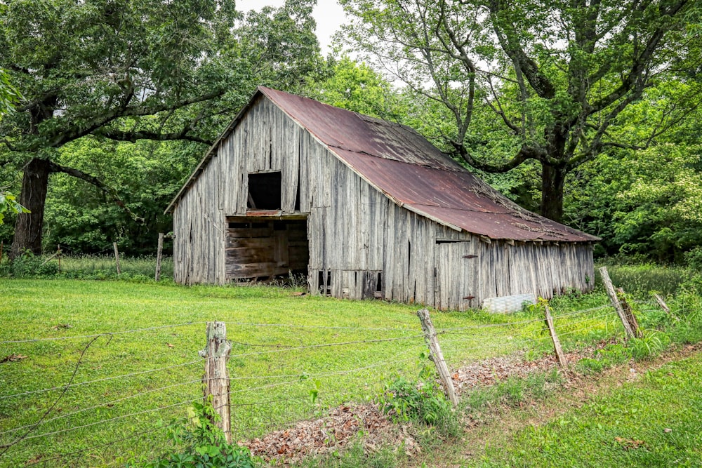 brown wooden house near green trees during daytime