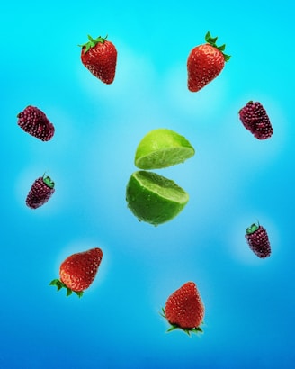 A vibrant arrangement of assorted fruits with a fine mist backdrop.