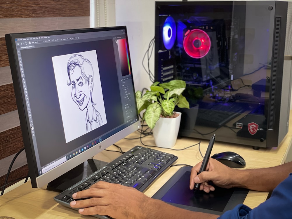 person using computer on brown wooden desk