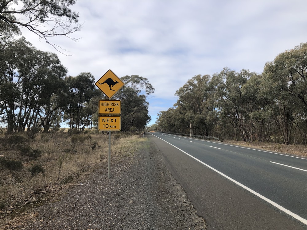 yellow and black road sign