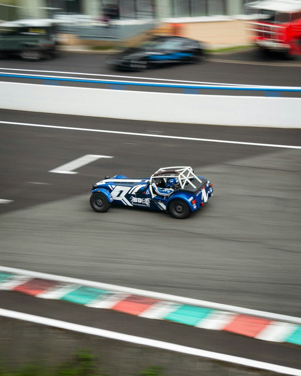 white and black racing car on track field