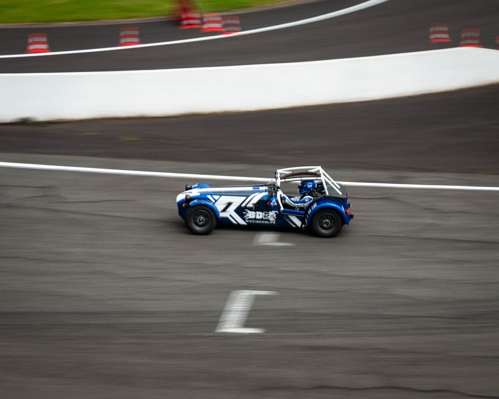 blue and black racing car on track field