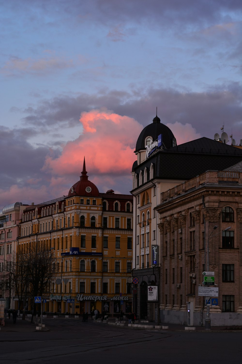 brown concrete building under cloudy sky during daytime