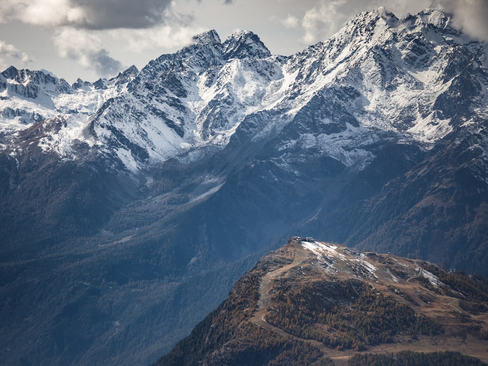 snow covered mountain under cloudy sky during daytime