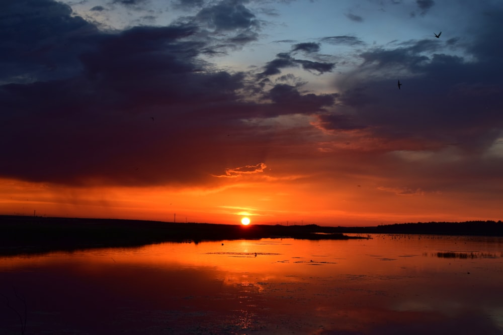 body of water during sunset