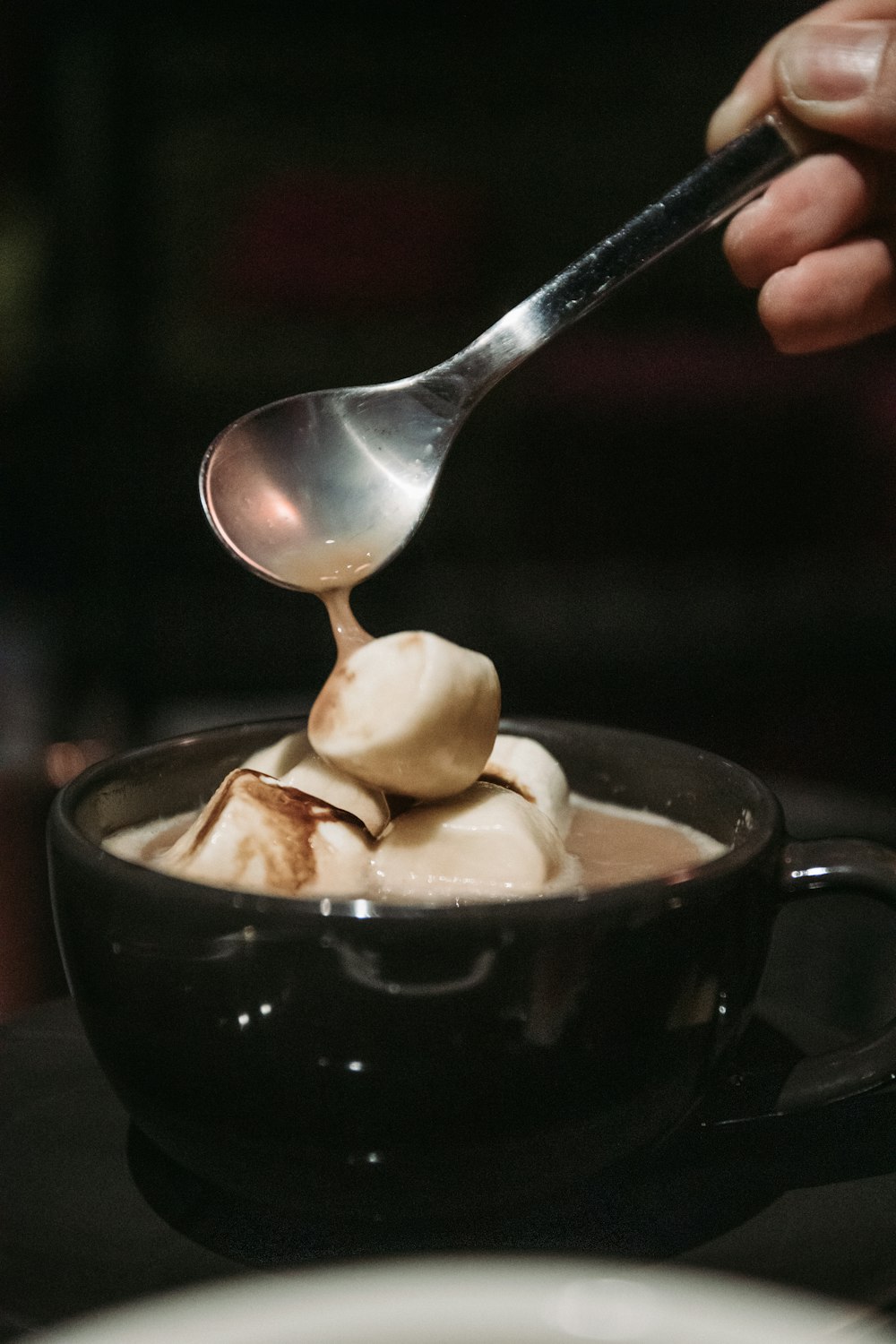 person holding stainless steel spoon