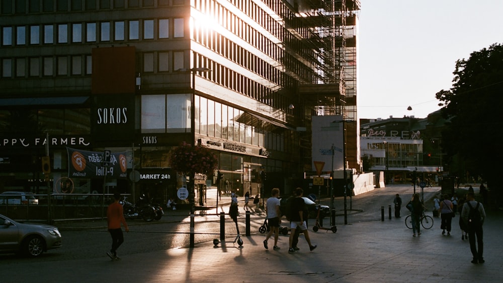 people walking on sidewalk near building during daytime