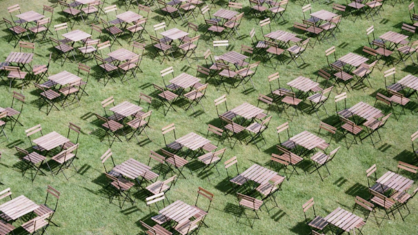 A bright, neatly arranged set of foldable tables ready for an outdoor event.