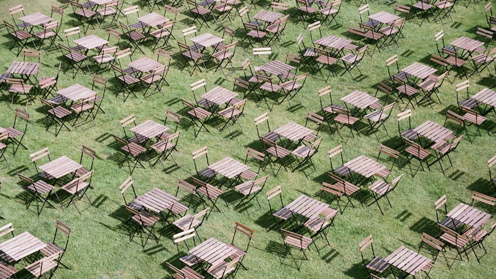 green and brown wooden folding chairs on green grass field