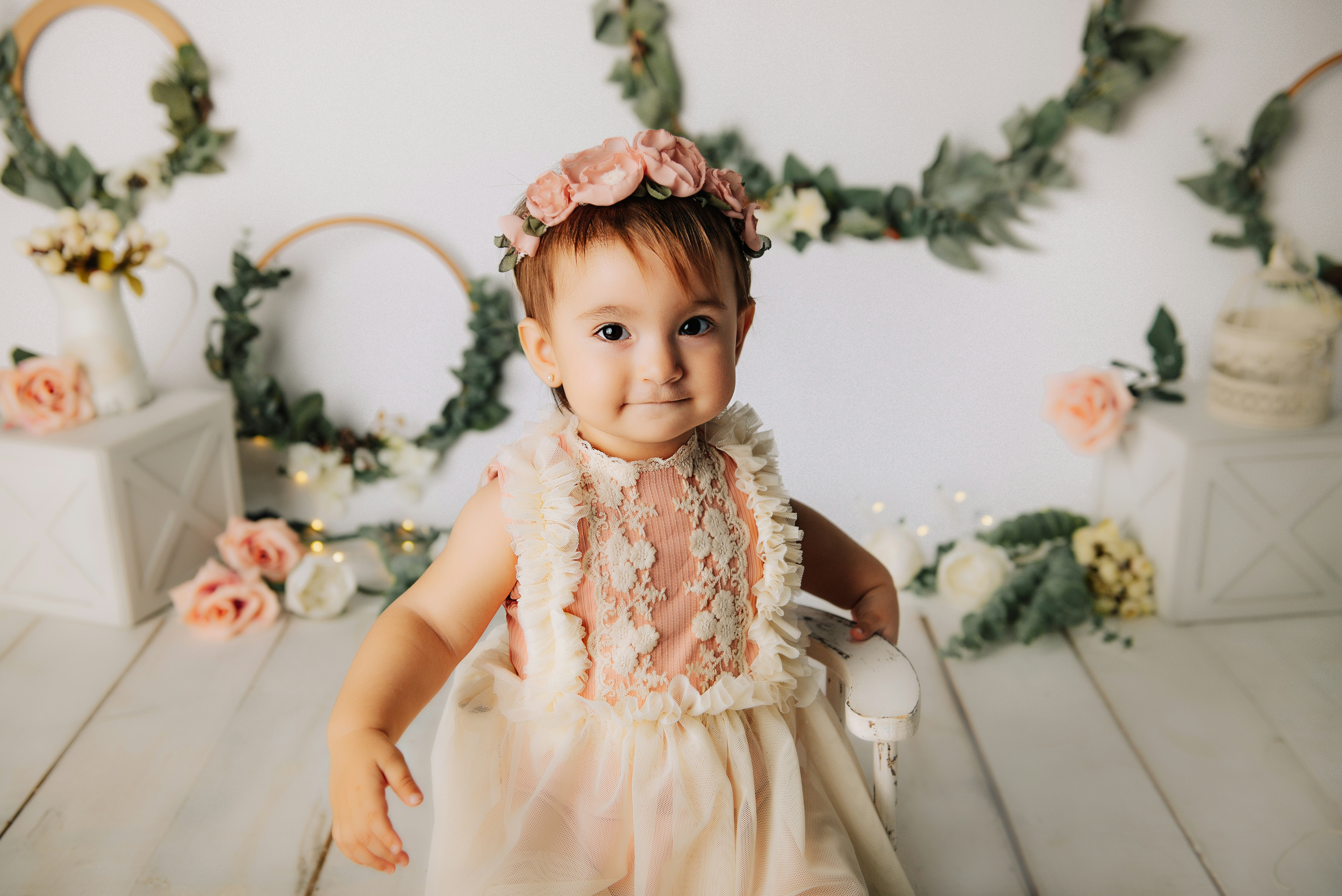 girl in white dress sitting on white chair