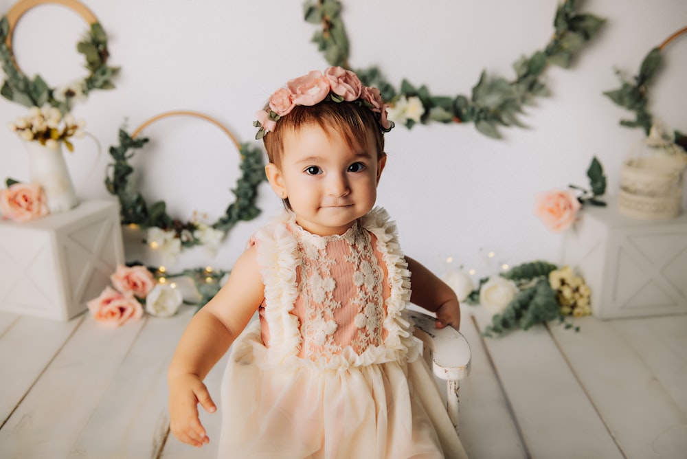 girl in white dress sitting on white chair