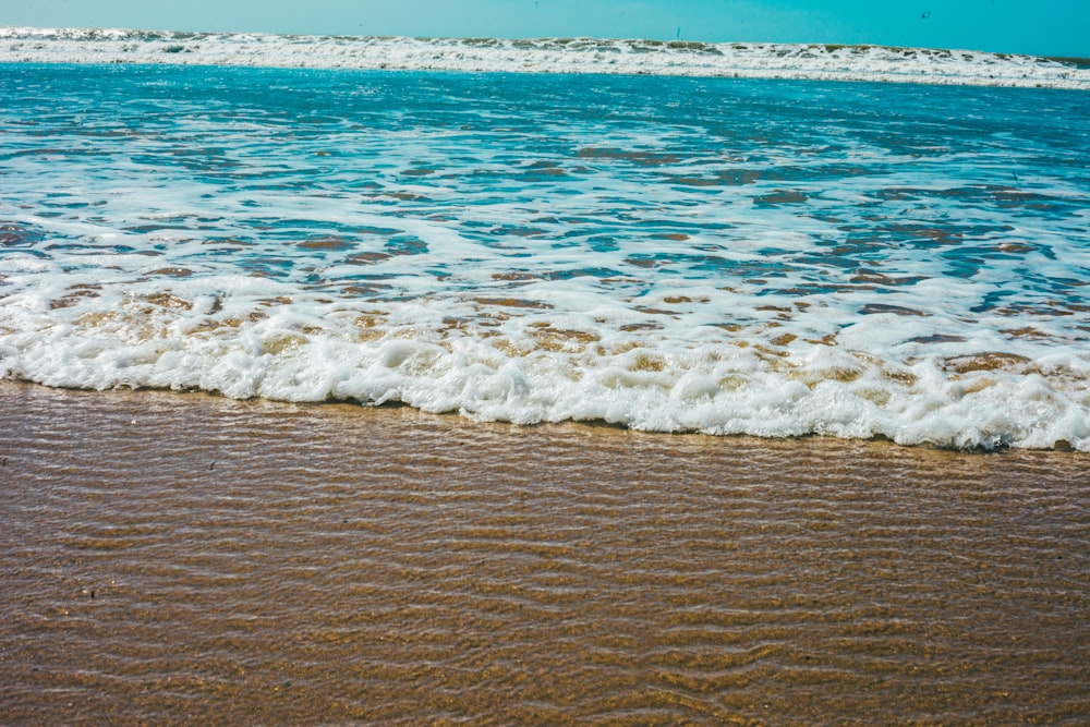 a beach with waves coming in and out of the water