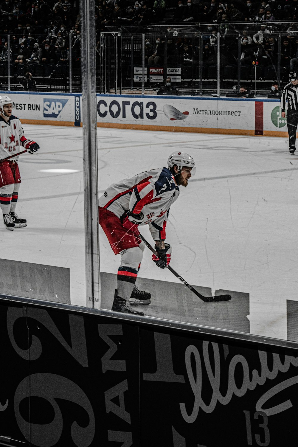 man in red and white ice hockey jersey playing ice hockey