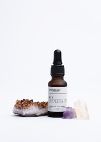 a bottle of lavender and sea salt next to a rock