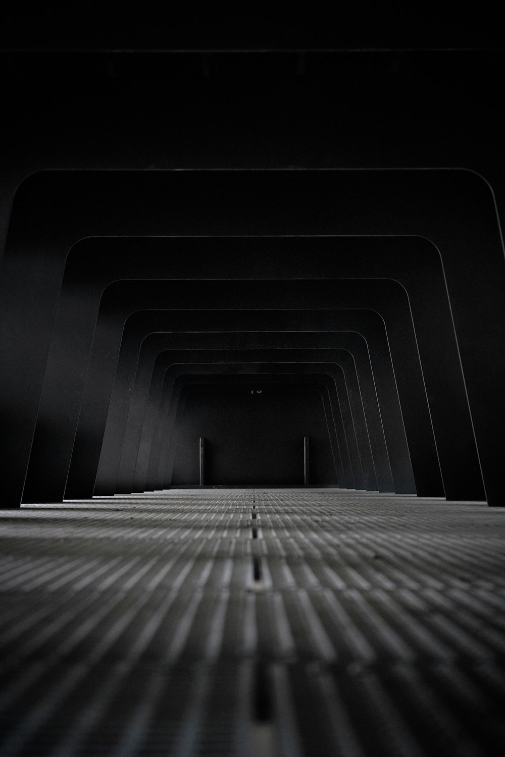 black and white tunnel in grayscale photography