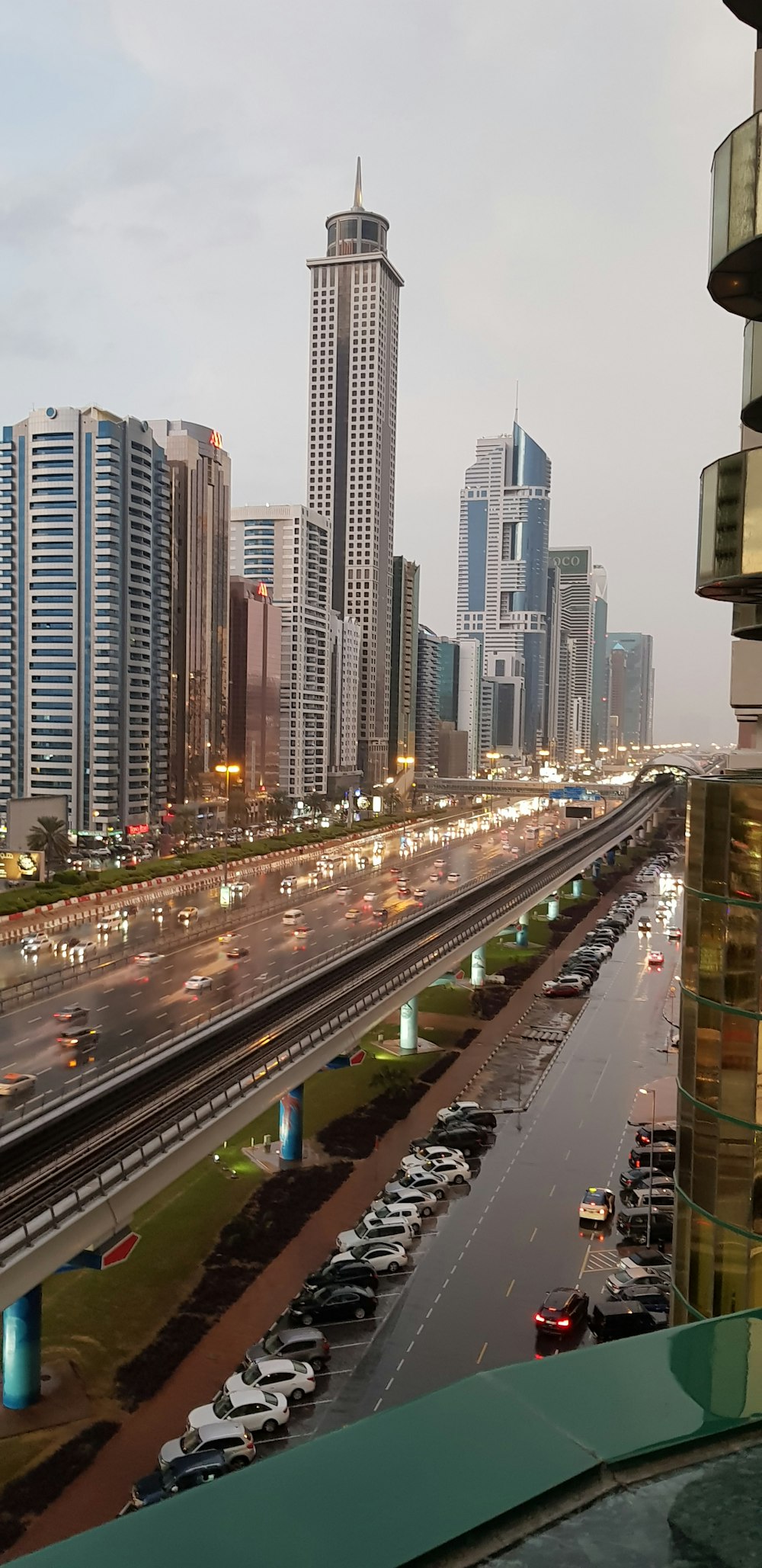 cars on road near high rise buildings during daytime