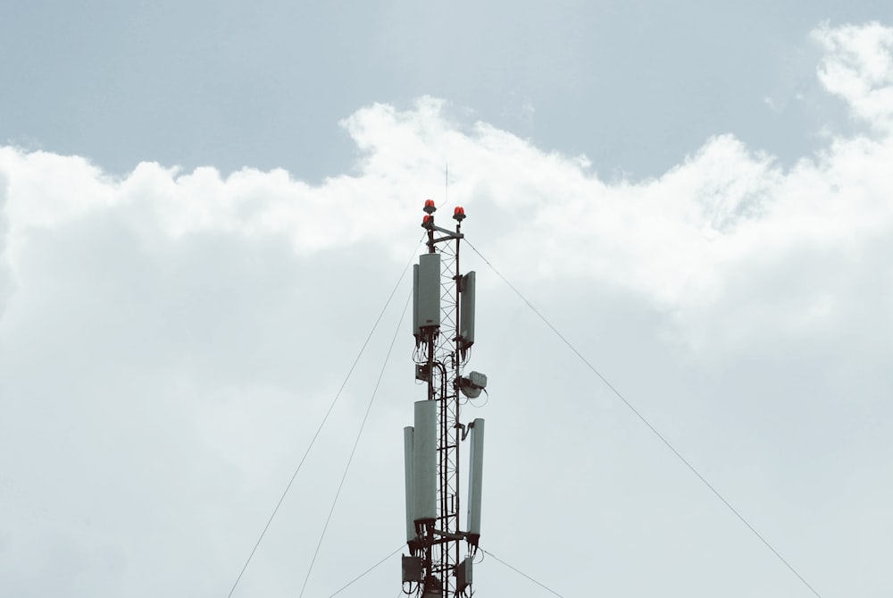 black and white metal tower under white clouds