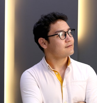 man in white dress shirt wearing black framed eyeglasses