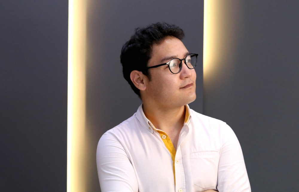 man in white dress shirt wearing black framed eyeglasses