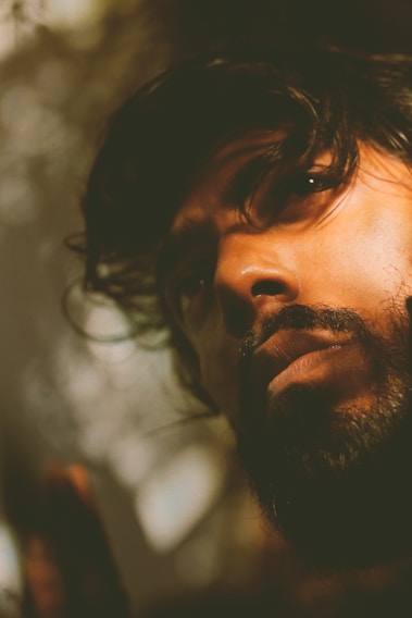 A close-up portrait of Neptale S Roa III, capturing a thoughtful expression with soft natural lighting.