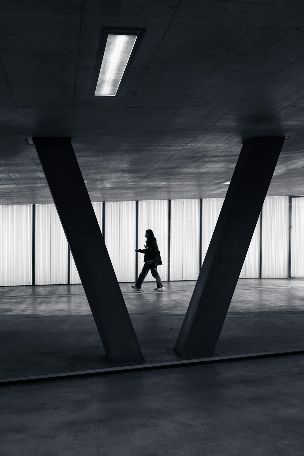 silhouette of 2 person walking on gray concrete floor