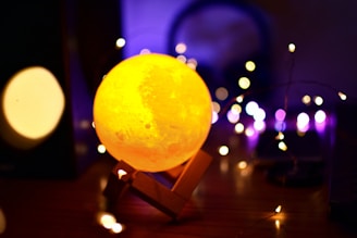 A cozy event setting featuring personalized 3D printed moon lamps glowing softly on tables.