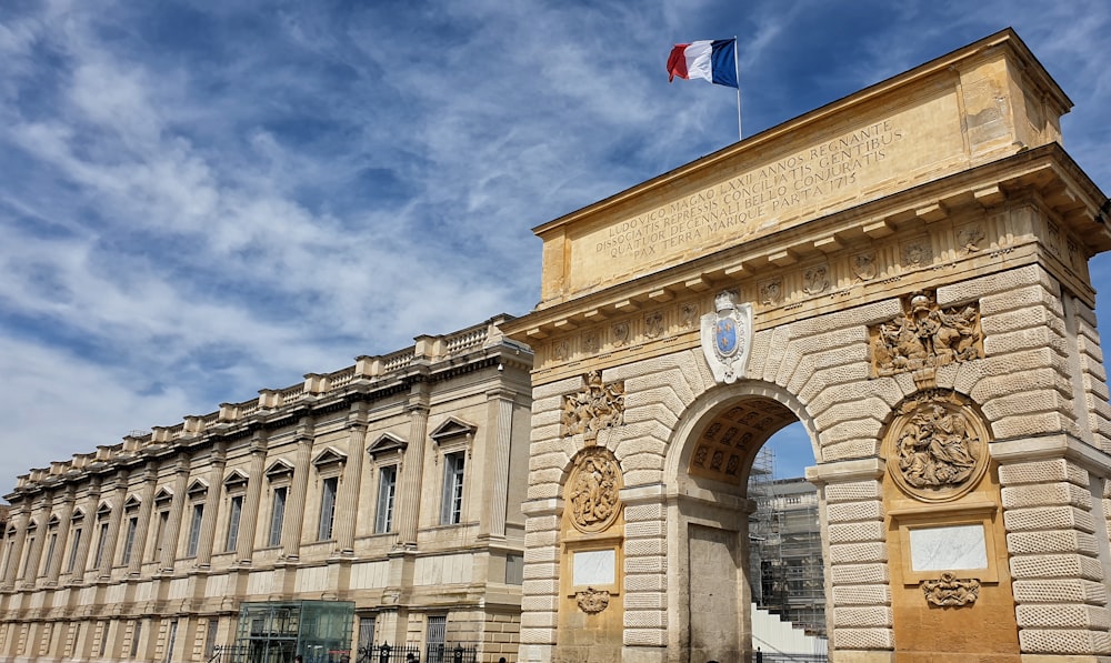 beige concrete building with flag of us a during daytime