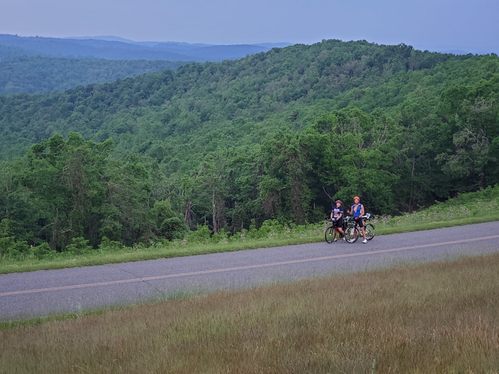 people riding motorcycle on road during daytime