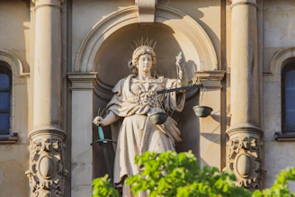 statue of man holding cross
