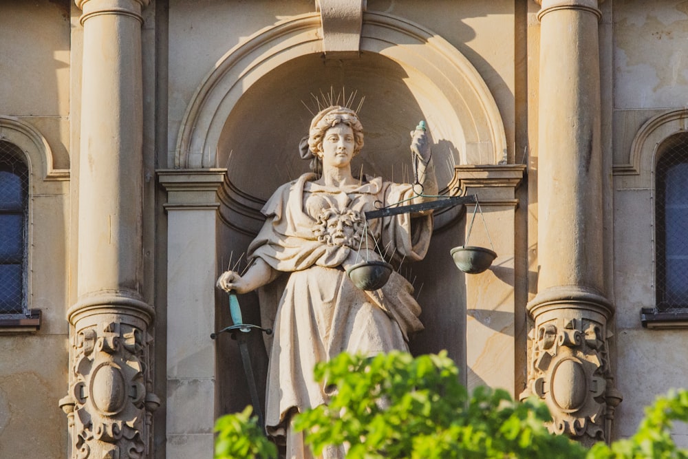 statue of man holding cross