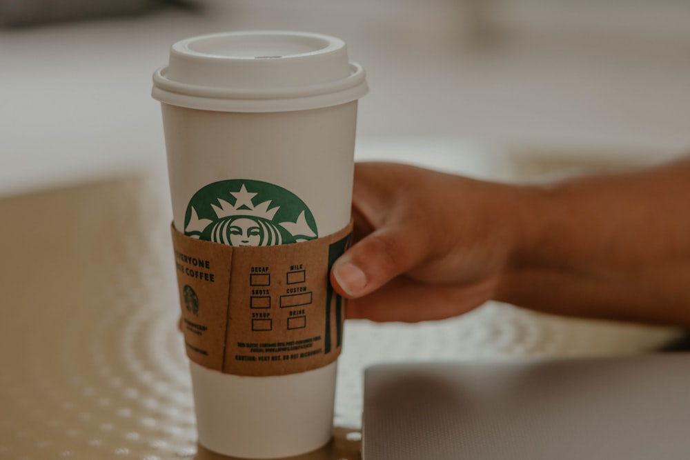 white and green starbucks disposable cup